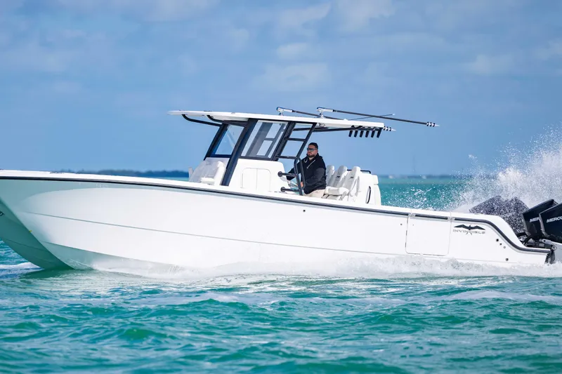 Slide: The Image of 2025 Invincible 35 Catamaran cruising on open water, showcasing sleek design and performance. - 48