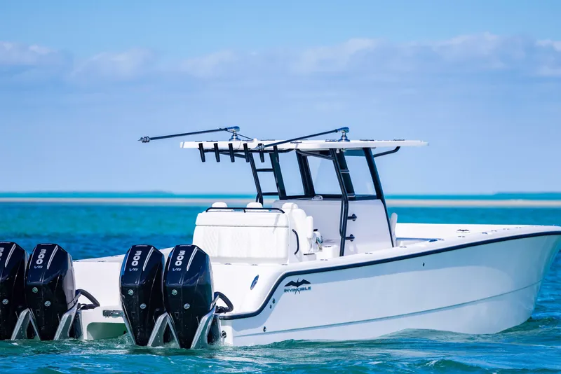 Slide: The Image of 2025 Invincible 35 Catamaran on clear blue water, featuring powerful outboard engines. - 5