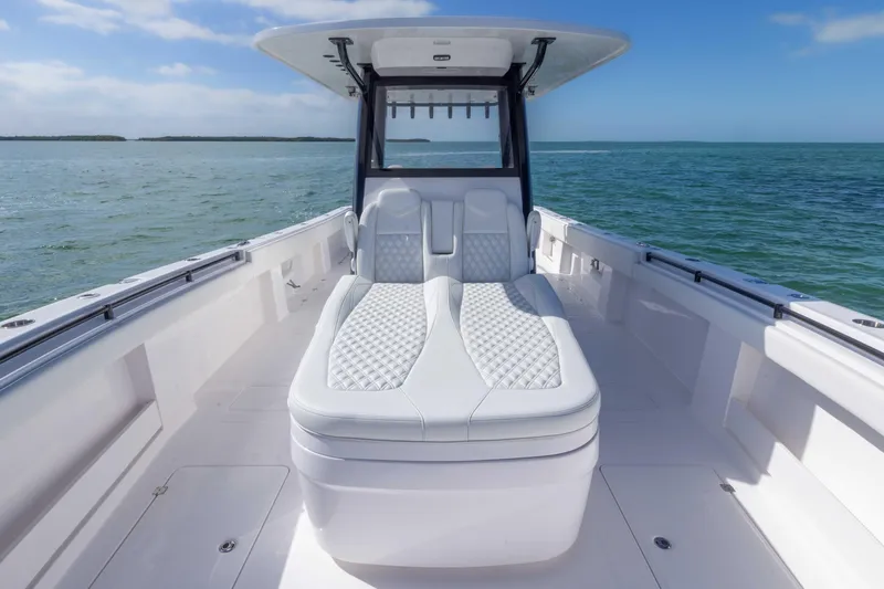 Slide: The Image of 2025 Invincible 35 Catamaran with luxurious seating on open water. - 9