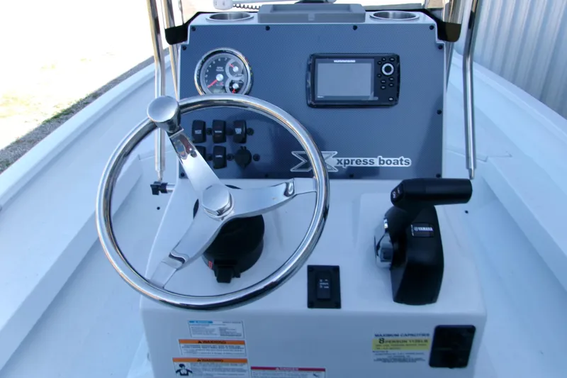 Slide: The Image of 2026 Xpress H22B Bay boat console with steering wheel and controls. - 11