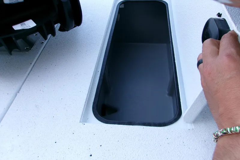 Slide: The Image of 2026 Xpress H22B Bay boat storage compartment with hand opening lid. - 12