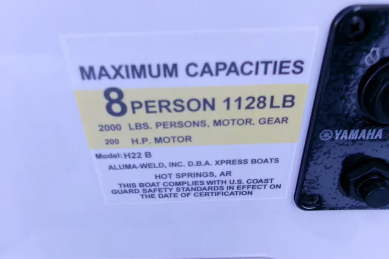 Slide: The Image of Maximum capacity label on 2026 Xpress H22B Bay boat, 8 persons, 2000 lbs, 200 HP motor. - 4