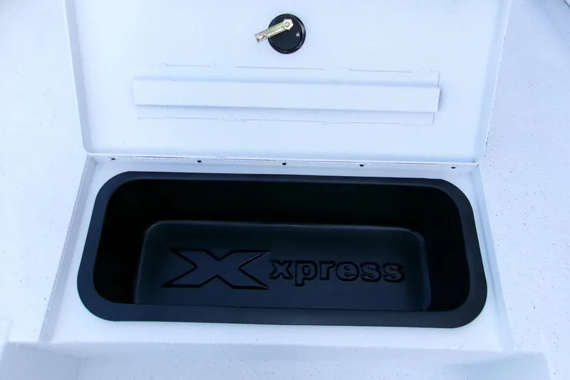Slide: The Image of Open storage compartment of 2026 Xpress H22B Bay boat with logo inside. - 8