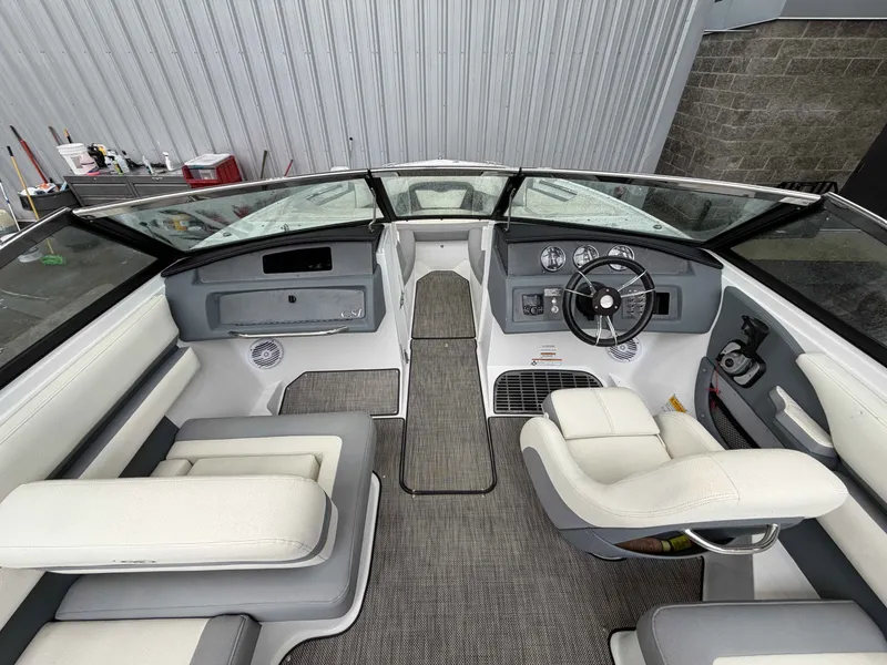 Slide: The Image of Interior of a 2017 Cobalt CS1 boat with steering wheel and seating. - 14