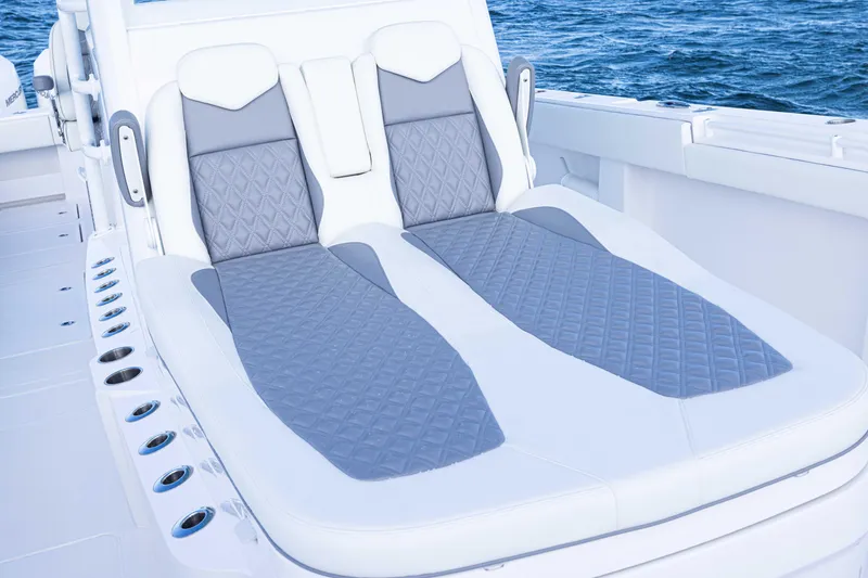 Slide: The Image of Luxury seating on 2025 Invincible 35 Catamaran, featuring elegant design and ocean backdrop. - 10