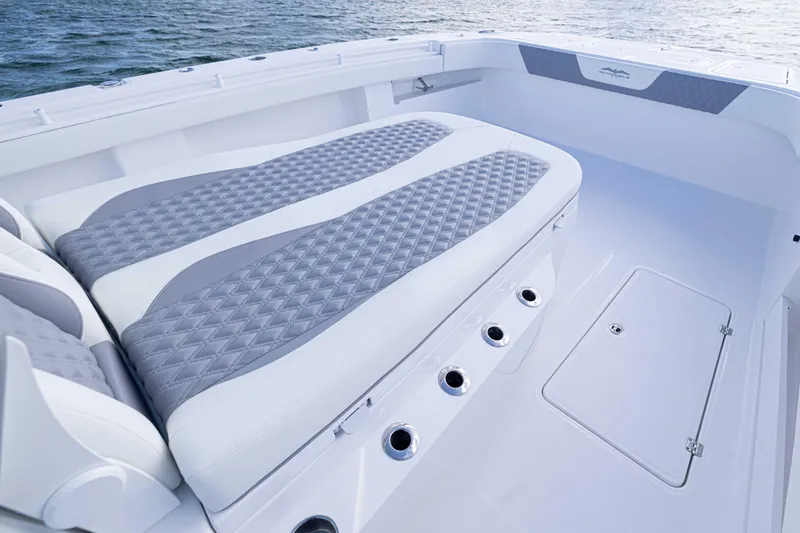 Slide: The Image of 2025 Invincible 35 Catamaran interior with cushioned seating and ocean backdrop. - 13