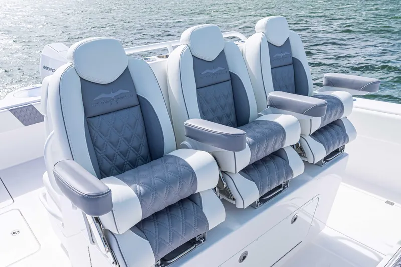 Slide: The Image of Luxurious seating on 2025 Invincible 35 Catamaran, featuring plush, ergonomic design with ocean backdrop. - 15