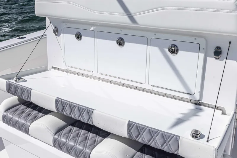 Slide: The Image of Luxury seating on 2025 Invincible 35 Catamaran with quilted upholstery and storage compartments. - 19