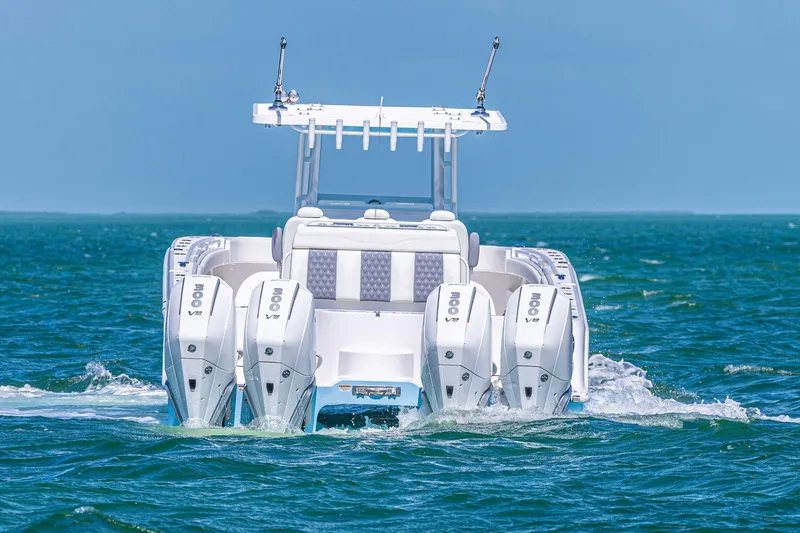 Slide: The Image of 2025 Invincible 35 Catamaran with quad engines cruising on open water. - 2