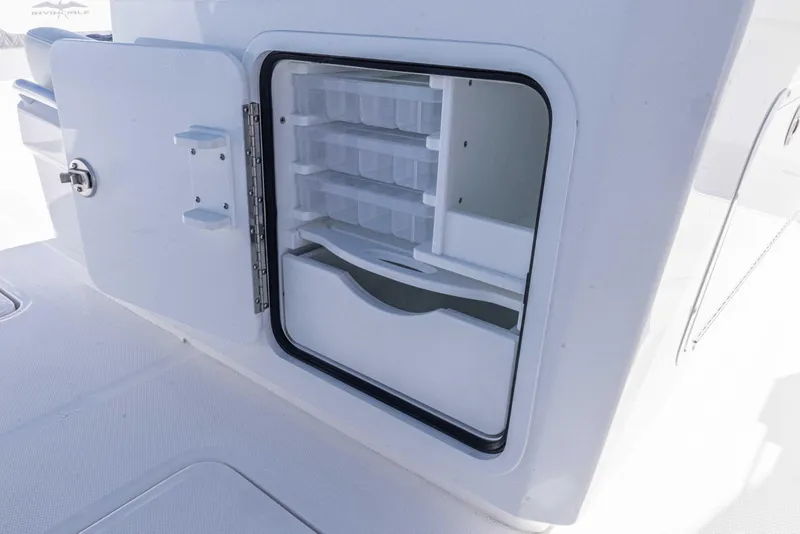 Slide: The Image of Open storage compartment on 2025 Invincible 35 Catamaran, showcasing organized interior shelves. - 25