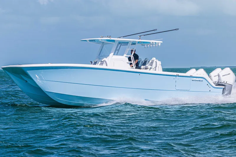 Slide: The Image of 2025 Invincible 35 Catamaran cruising on open water, showcasing sleek design and powerful engines. - 29
