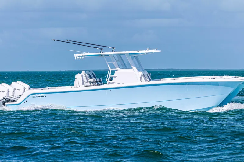 Slide: The Image of 2025 Invincible 35 Catamaran cruising on open water, showcasing sleek design and powerful engines. - 3