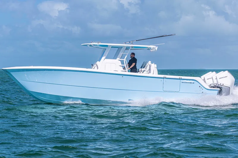 Slide: The Image of 2025 Invincible 35 Catamaran cruising on open water under clear skies. - 30