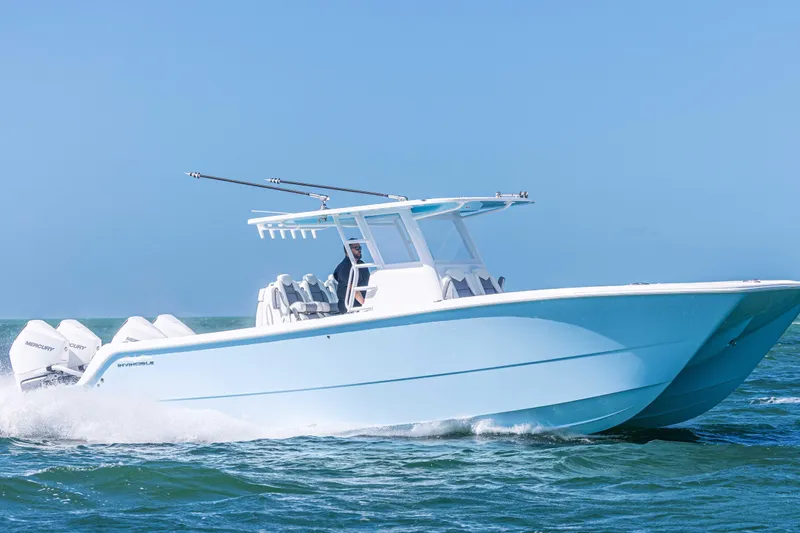 Slide: The Image of 2025 Invincible 35 Catamaran cruising on open water, showcasing sleek design and powerful engines. - 32