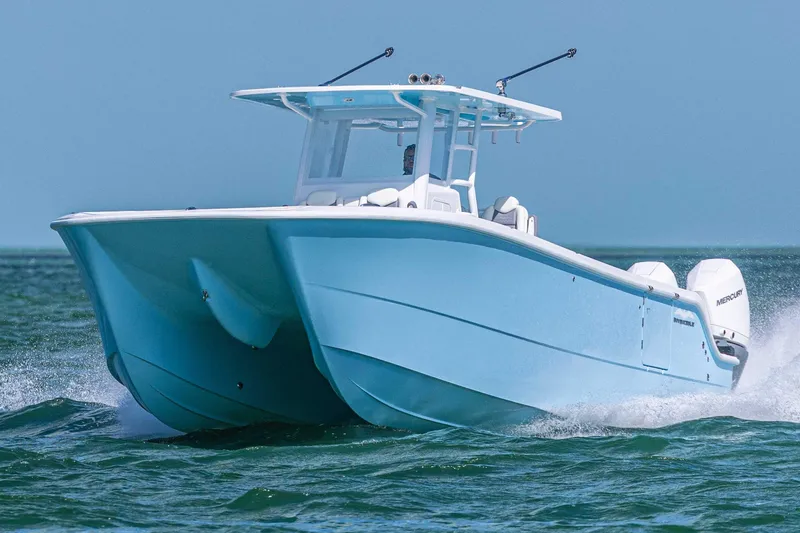 Slide: The Image of 2025 Invincible 35 Catamaran cruising on open water, showcasing sleek design and performance. - 34