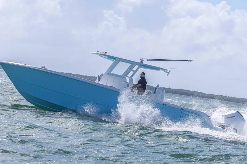 Slide: The Image of 2025 Invincible 35 Catamaran cruising on open water, showcasing sleek design and performance. - 35