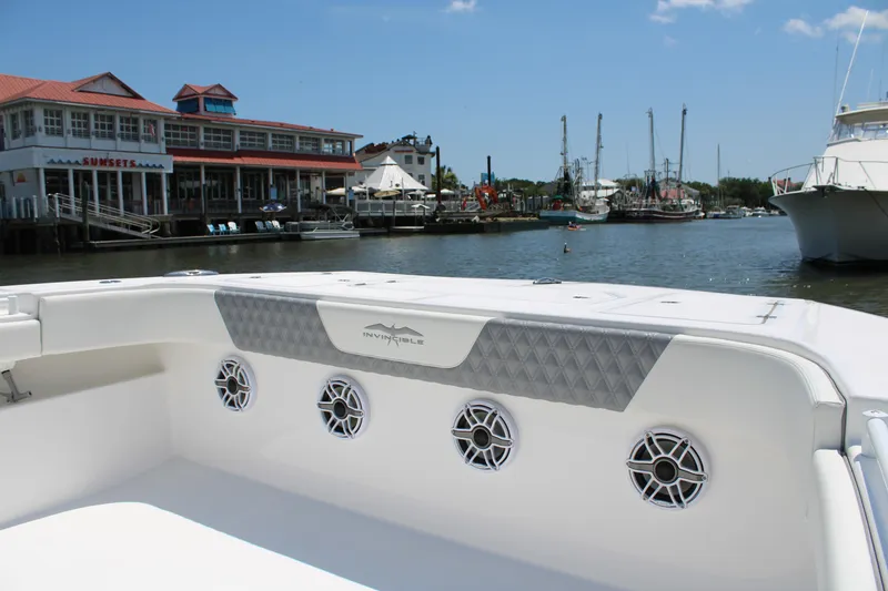 Slide: The Image of 2025 Invincible 35 Catamaran docked near waterfront buildings and boats. - 5