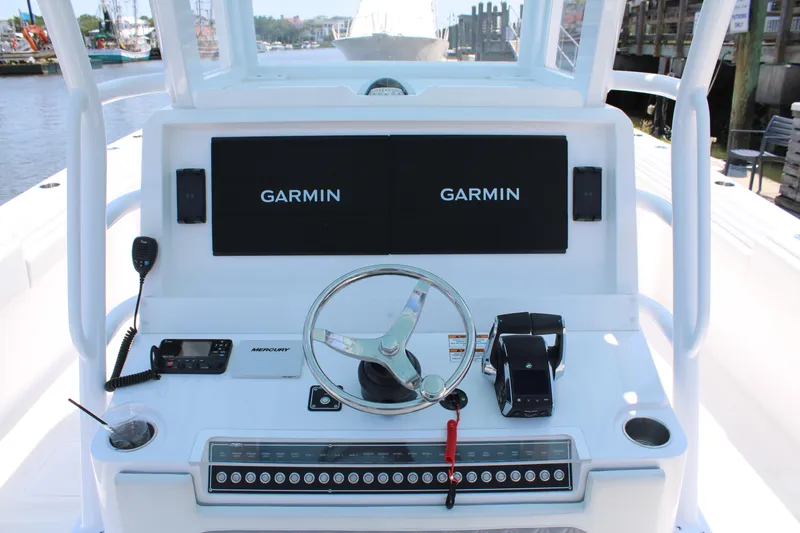 Slide: The Image of 2025 Invincible 35 Catamaran helm with Garmin displays and Mercury controls. - 6