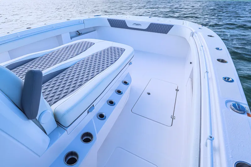 Slide: The Image of 2025 Invincible 35 Catamaran interior with cushioned seating and ocean view. - 7