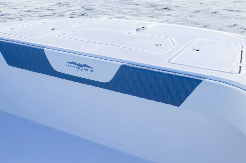 Slide: The Image of 2025 Invincible 35 Catamaran boat deck with logo, featuring sleek design and ocean backdrop. - 8