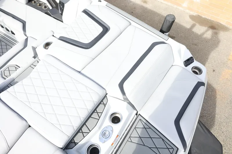 Slide: The Image of 2022 Tigé 23ZX boat interior with white quilted seats and cup holders. - 12
