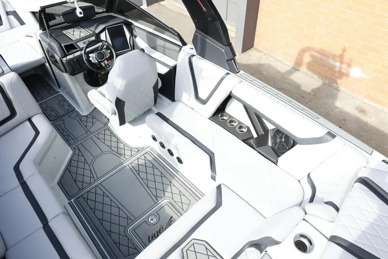 Slide: The Image of 2022 Tigé 23ZX boat interior with modern design, white seating, and advanced dashboard controls. - 14