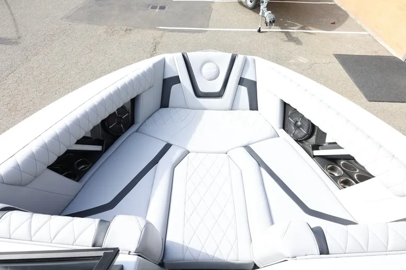Slide: The Image of Luxurious interior of 2022 Tigé 23ZX boat with white quilted seating and cup holders. - 16