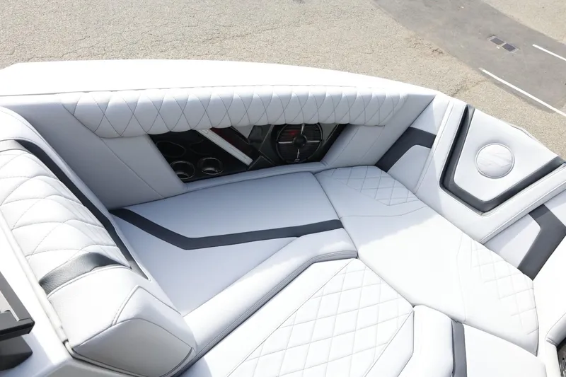 Slide: The Image of Luxurious interior of 2022 Tigé 23ZX boat with quilted white seating. - 17