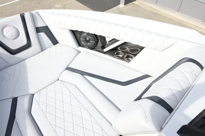 Slide: The Image of Luxurious interior of 2022 Tigé 23ZX boat with white quilted seating and cup holders. - 18