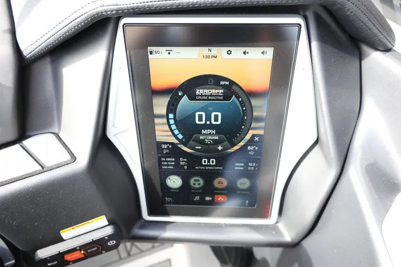 Slide: The Image of 2022 Tigé 23ZX boat dashboard with digital display showing speed and controls. - 23