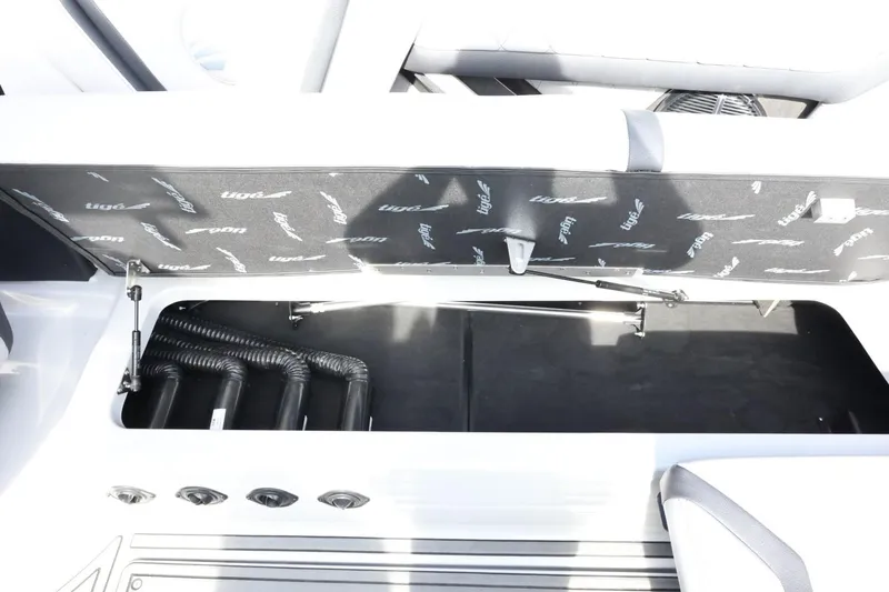 Slide: The Image of 2022 Tigé 23ZX boat storage compartment with open lid and visible interior. - 31
