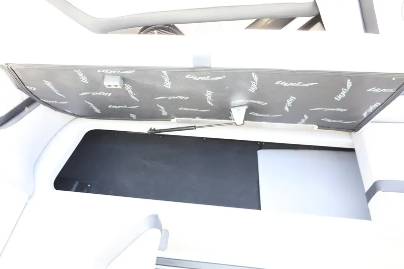 Slide: The Image of 2022 Tigé 23ZX boat storage compartment with open lid, showcasing interior space. - 33
