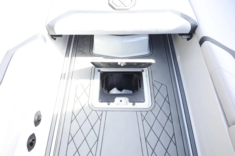 Slide: The Image of 2022 Tigé 23ZX boat interior with open storage compartment and sleek flooring design. - 34