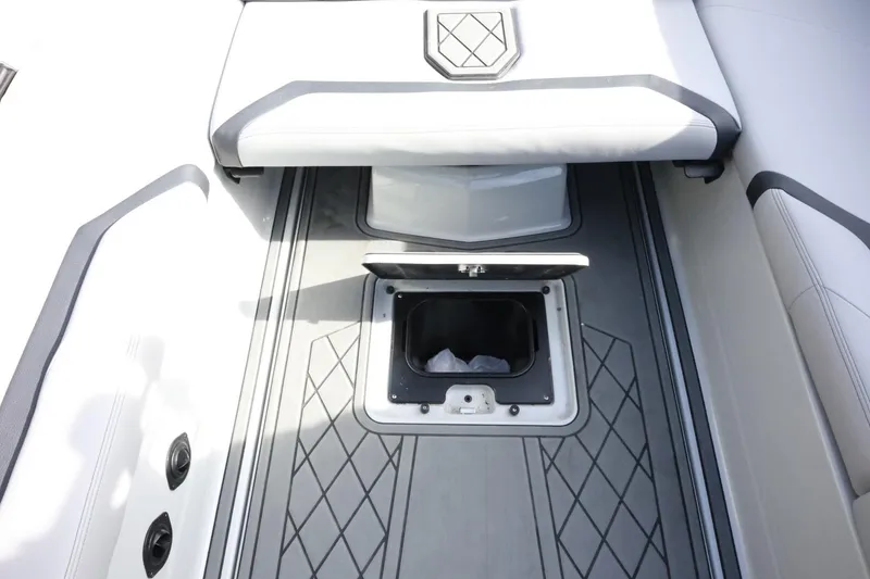 Slide: The Image of 2022 Tigé 23ZX boat interior with open storage compartment and cushioned seating. - 35