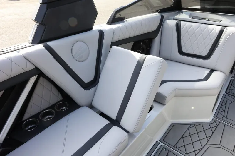 Slide: The Image of 2022 Tigé 23ZX boat interior with luxurious white and gray seating and cup holders. - 36