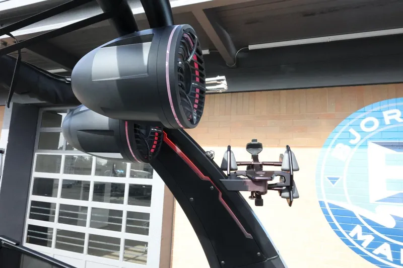 Slide: The Image of 2022 Tigé 23ZX boat speakers and wakeboard rack under a covered area. - 37