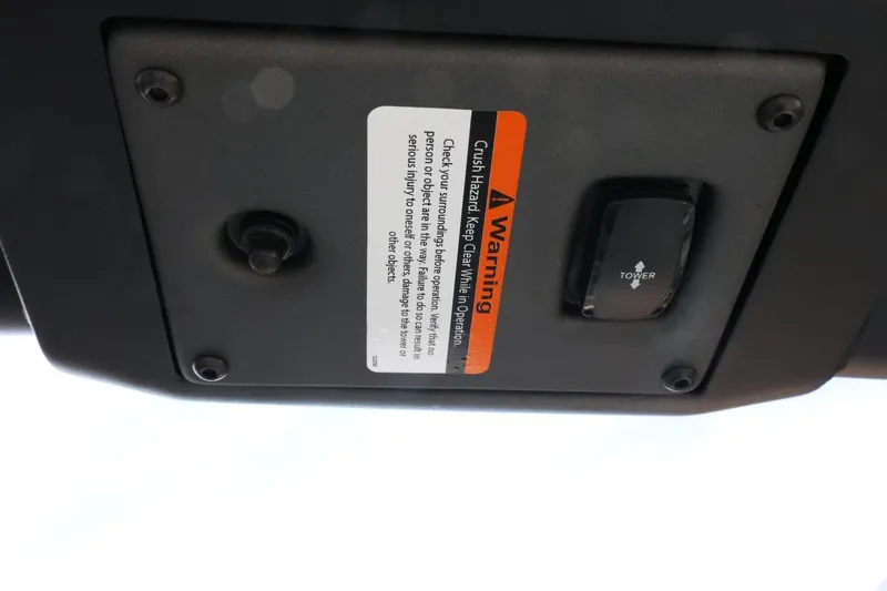 Slide: The Image of 2022 Tigé 23ZX boat control panel with warning label and tower switch. - 38