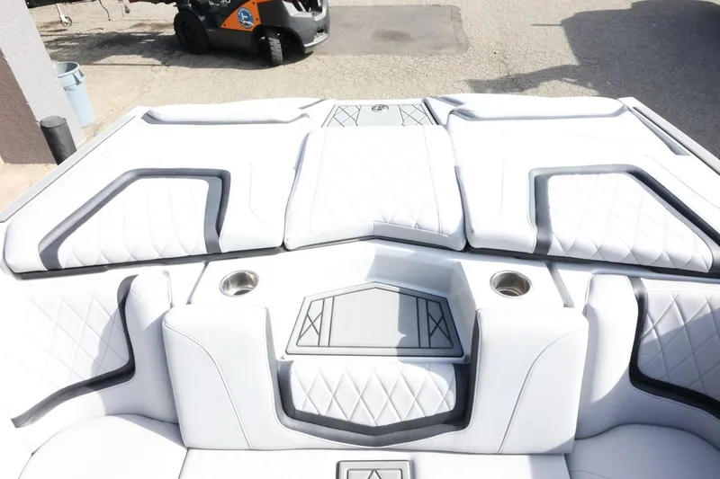 Slide: The Image of 2022 Tigé 23ZX boat interior with white quilted seats and cup holders. - 40