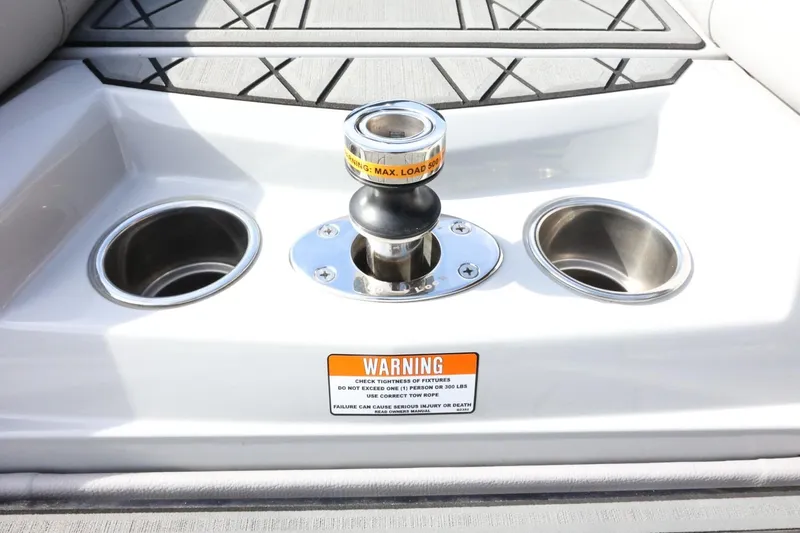 Slide: The Image of 2022 Tigé 23ZX boat tow point with cup holders and warning label. - 44