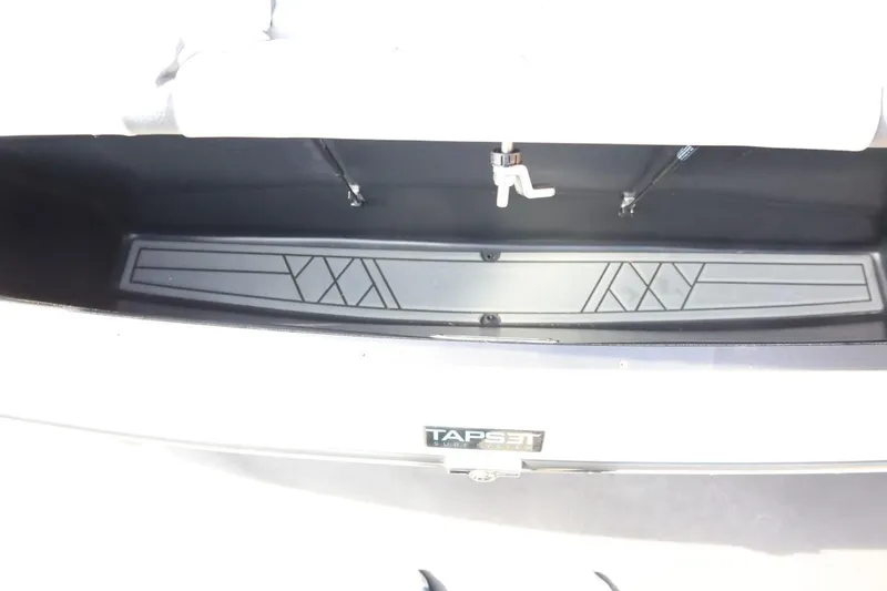 Slide: The Image of 2022 Tigé 23ZX boat storage compartment with TAPSET branding and geometric design. - 46