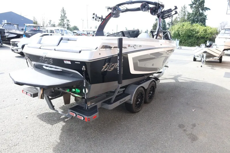 Slide: The Image of 2022 Tigé 23ZX boat on trailer, rear view, parked outdoors. - 8
