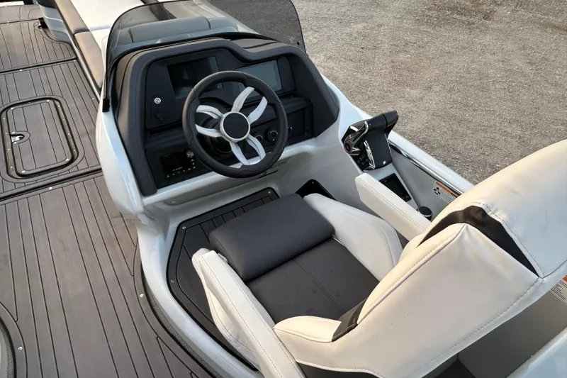 Slide: The Image of 2023 Manitou 270 boat cockpit with steering wheel and control panel. - 11