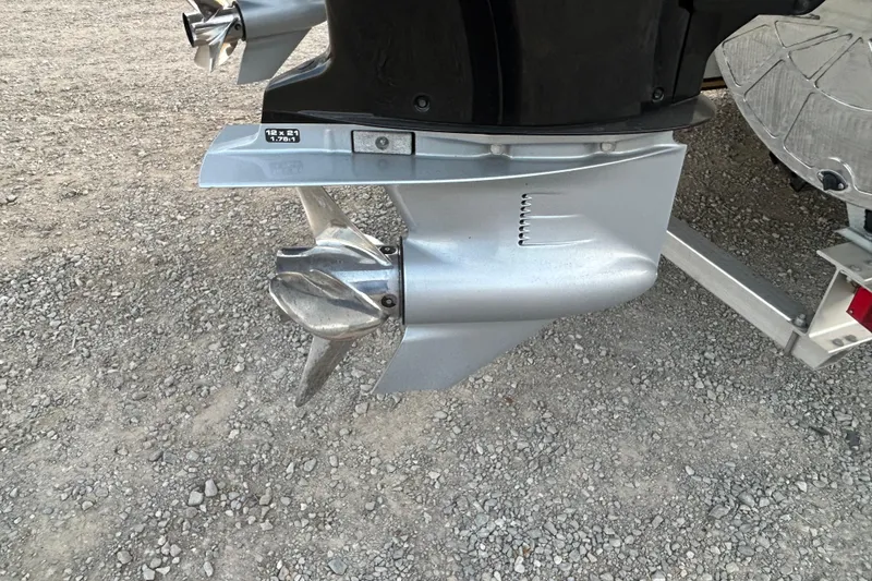 Slide: The Image of 2023 Manitou 270 boat propeller on gravel surface, showcasing sleek design and durability. - 17