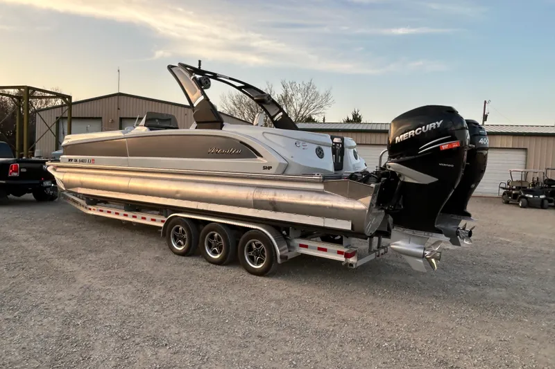 Slide: The Image of 2023 Manitou 270 pontoon boat with Mercury engines on a trailer. - 4