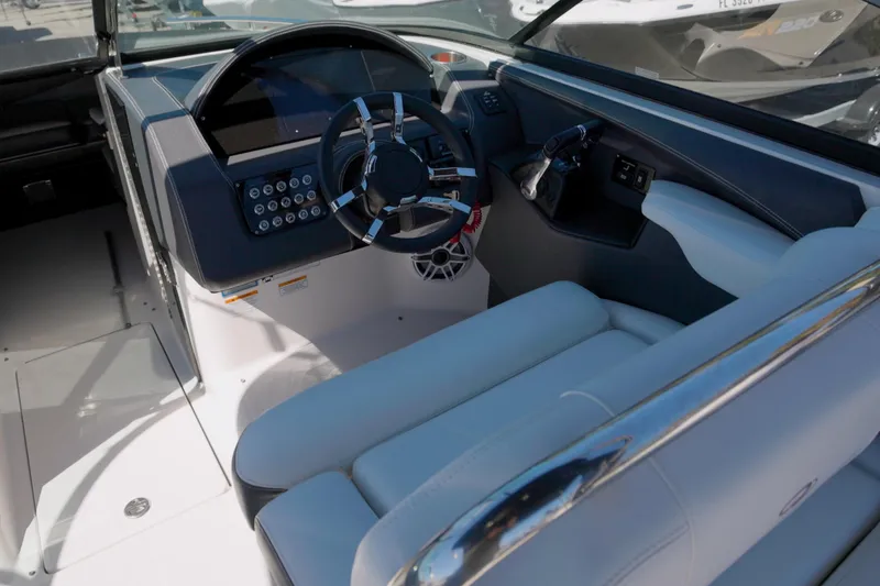 Slide: The Image of 2017 Regal 29 OBX boat cockpit with modern steering and controls. - 12
