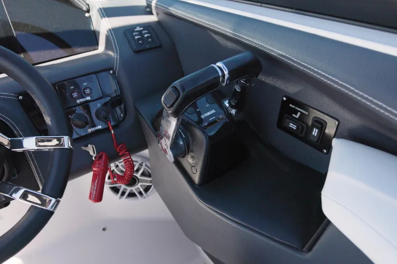 Slide: The Image of 2017 Regal 29 OBX boat dashboard with Yamaha controls and steering wheel. - 11
