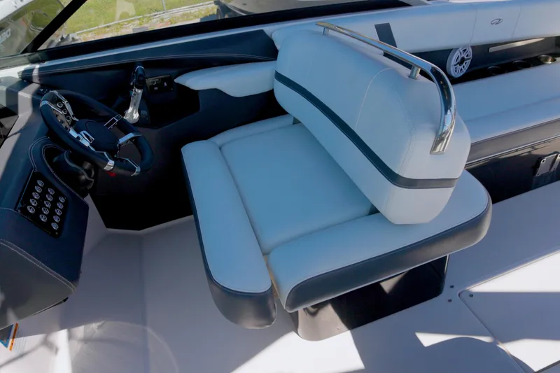 Slide: The Image of 2017 Regal 29 OBX boat interior with steering wheel and cushioned seating. - 7
