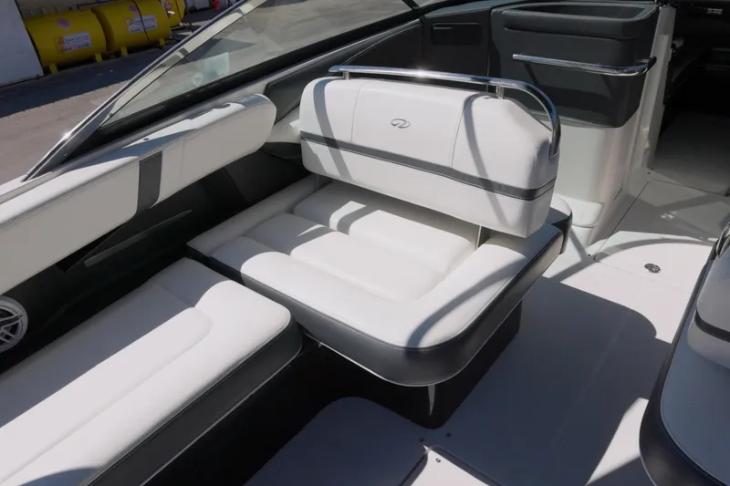 Slide: The Image of 2017 Regal 29 OBX boat interior with white cushioned seating and sleek design. - 5