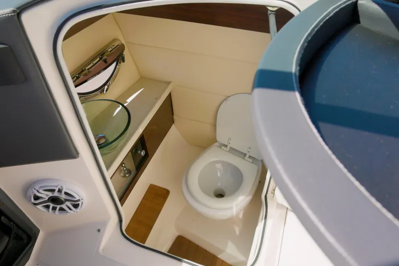Slide: The Image of 2017 Regal 29 OBX boat bathroom with toilet, sink, and speaker. - 10