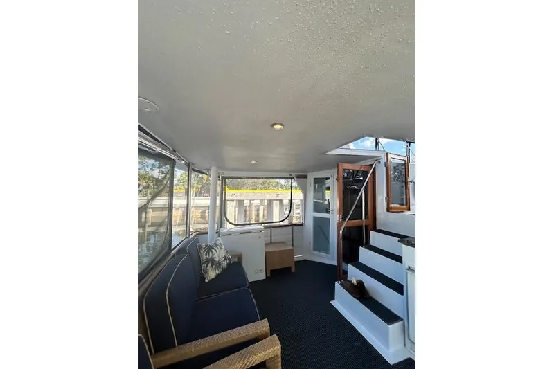 Slide: The Image of Interior of 1996 Jefferson 52 Rivanna Cockpit MY yacht, featuring seating and stairs. - 11